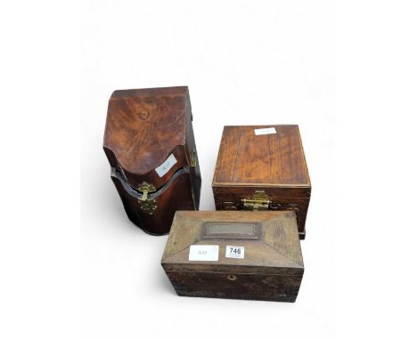 An early 19th Century mahogany tea caddy of sarcophagus form, with two compartments and central circular compartment (lacks b