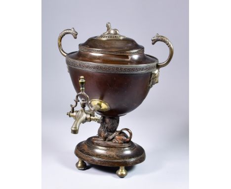 An English Regency Bronzed and Bronze Metal Samovar of Neo Classical Design, the lid with sphinx finial, lion mask ring handl