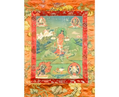 A Late 18th Century Tibetan Thangka, likely displaying Red Tara clasping the stem of a lotus and seated on a lion, 22.5ins (5