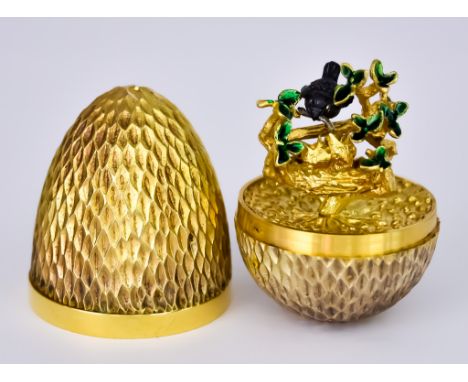 ***An Elizabeth II Silver Gilt "Surprise" Egg by Stuart Devlin, London 1976, limited no.183, the textured shell containing ox