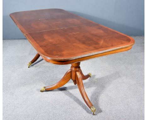 A Modern Mahogany Twin Pedestal Dining Table of "Regency" Design, with cross banding and reeded edge to top, plain frieze, on