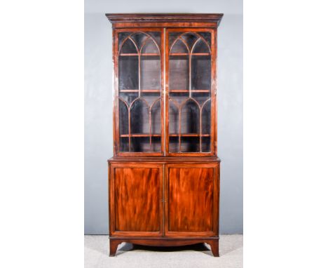 A George III Mahogany Bookcase, the upper part with moulded cornice, plain frieze, fitted three shelves enclosed by a pair of