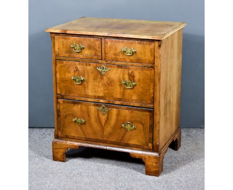 A Walnut Chest of Drawers of 18th Century Design, with quarter veneered and crossbanded top, fitted two short and two long dr
