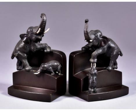 A Pair of Brown Patinated Bronze Bookends of Stepped Form, Meiji Period, modelled with adult and juvenile elephants, one sign