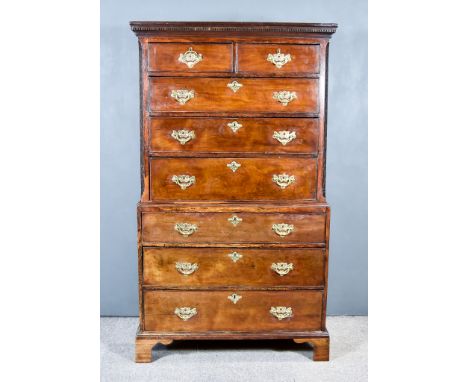 A George III Mahogany Tallboy in the "Chippendale" Manner, the upper part with moulded cornice and dentil frieze, fitted two 