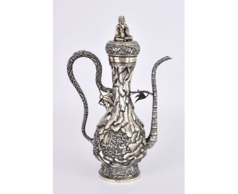 A Tibetan Silvery Gilt Metal Ewer and Cover, the cover with seated sage finial, rim chased and embossed with bats and clouds,
