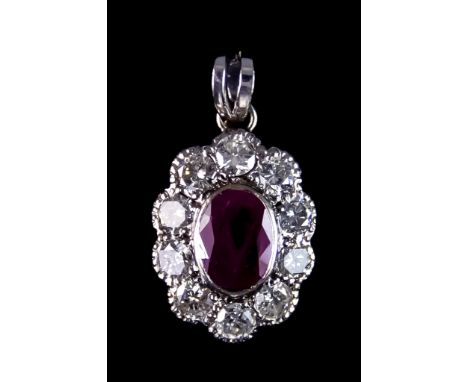 A Ruby and Diamond Pendant, set in the form of a flower head pendant with a centre ruby, approximately 1ct, surrounded by bri