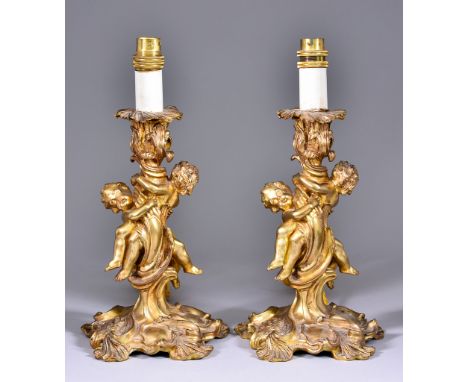 A Pair of French Ormolu Candlesticks of Louis XV Design, 19th Century, after a design by Juste Aurele Meissonnier, the stems 