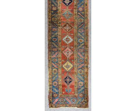 An Early 20th Century Yalameh Runner, woven in colours of ivory, navy blue, wine and fawn, the central stylised pole medallio