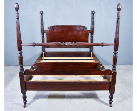 A Mahogany 4ft 6ins Bedstead of Georgian Design with Shaped Head and Footboards, on turned and reeded columns with pineapple 