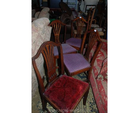 A set of four Oak and Elm framed Dining Chairs having fretworked splats, three with tapestry upholstered drop-in seats, one h
