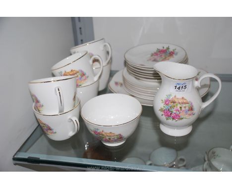 A fine bone china part Teaset with pretty thatched cottage design including six cups, saucers and tea plates, milk jug and su