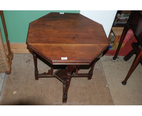 An Edwardian Mahogany octagonal topped Occasional Table standing on turned leg united by a lower shelf and additional support