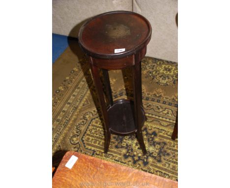 A plant stand with shelf.