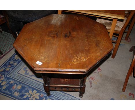 An early 20th c. octagonal Occasional Table having lightwood inlay, the turned legs united by a galleried lower shelf, 29 3/4