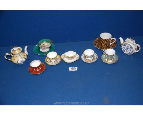 A quantity of miniature cups and saucers and two Regal teapots