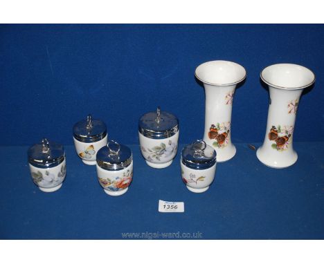 Five Royal Worcester decorated with butterflies egg coddlers, one large and four small along with a pair of vases.