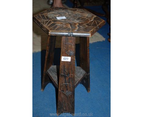 An Arts and Crafts foliage/floral carved hexagonal top Occasional Table with triangular lower shelf uniting the supports, 12'