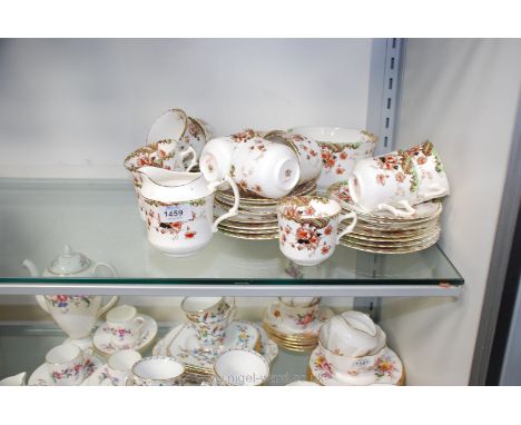 A part teaset 'Poppy' including eleven cups, twelve saucers, twelve tea plates, milk jug, slop bowl, bread and butter plate, 