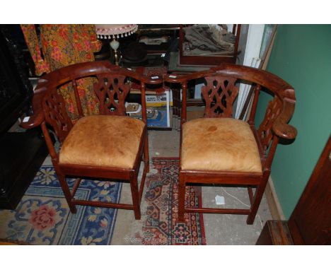 A pair of unusual Corner elbow Chairs having uncommon grain pattern to the top rails and to the fretworked splats, standing o
