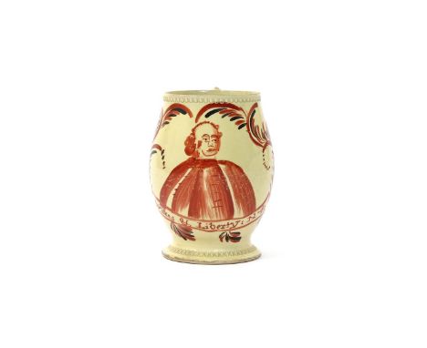 A good and rare political creamware mug  2nd half 18th century, the barrel shape painted in red and black with a portrait of 