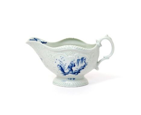 A Worcester blue and white sauceboat  c.1765, painted with the Man with a Bomb pattern, a solitary Chinese figure holding his
