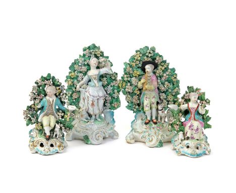 Two pairs of Derby figures  c.1765, one pair of a piping shepherd and his companion, he with a dog seated beside him, she wit