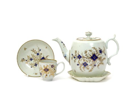 A Flight Worcester teapot and cover with stand  c.1783-92, richly painted with blue and gilt sprays of flowers within a gilt 