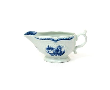 A Worcester blue and white strap-fluted sauceboat  c.1765, painted with the Little Fisherman pattern, the reverse with a land