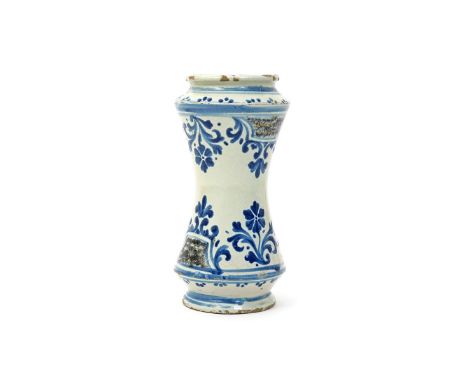 An Italian (Sicily) maiolica albarello  c.1700, the waisted form painted with a formal design of blue flower sprays flanking 