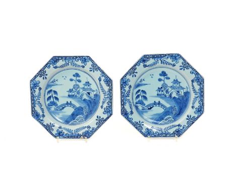 A pair of delftware octagonal plates  mid 18th century, each painted in blue with two figures standing on a bridge linking is