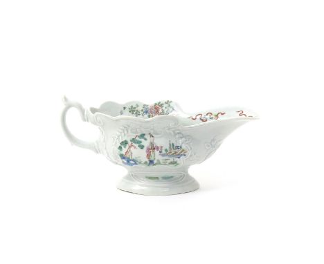 A Worcester high-footed moulded sauceboat  c.1753-54, each side moulded with a rococo panel containing a Long Eliza figure st