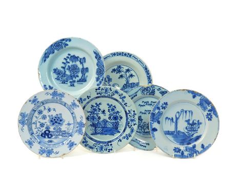 Six delftware plates  18th century, variously decorated in blue with Oriental landscapes, with arrangements of bamboo, peony,