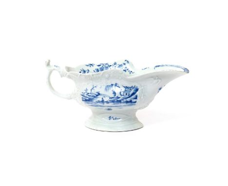 A large Worcester blue and white sauceboat  c.1755, painted with the Fisherman on a Towering Rock pattern within moulded pane