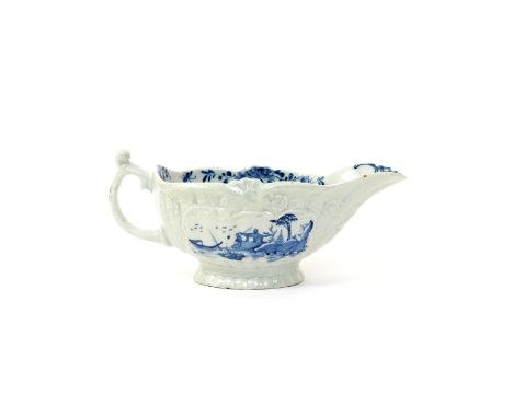 A Worcester blue and white sauceboat  c.1756, painted with the Boatman pattern, each side moulded with a shaped panel, to one