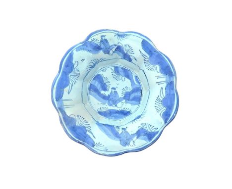 A delftware small lobed dish or cracknell  c.1660-80, possibly London or Continental, painted in blue with a seated Chinaman 