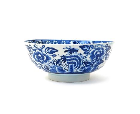 An Isleworth blue and white bowl  c.1770, painted with peony blooms issuing from rockwork, the interior with a single peony b