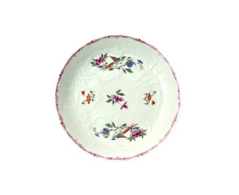A rare Worcester saucer  c.1755-56, finely potted and moulded with floral panels and painted in the famille rose palette with