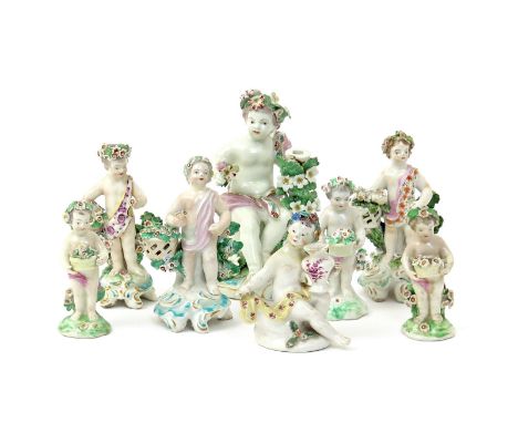 Seven Derby figures of putti  c.1760-80, the largest seated and supporting a candlestick entwined with flowers, three standin