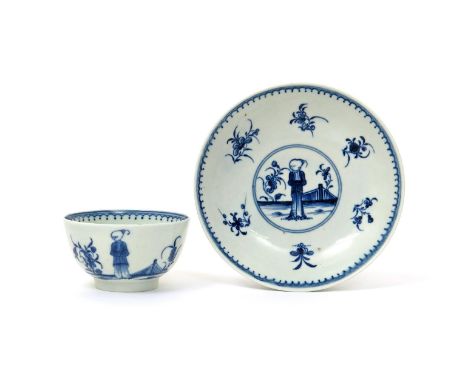 A Worcester blue and white teabowl and saucer  c.1770, painted with the Waiting Chinaman pattern, a solitary figure standing 