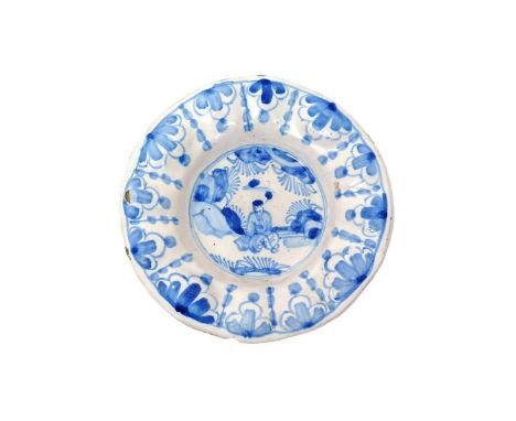 An early London delftware low footed dish  c.1670, with an unusually moulded rim of alternating ovals and gadroons, painted w