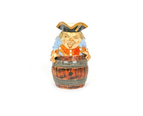 A Wayte & Ridge comical Toby jug  c.1864, modelled as a Prussian soldier in blue and orange uniform, wedged into a wooden bar