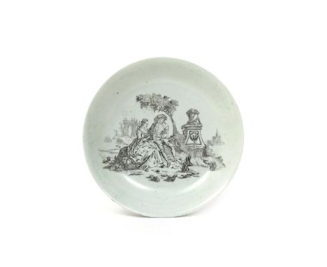 An early Worcester saucer c.1754, printed in black in 'Smoky Primitive' style with The Flute Lesson, a couple seated beside g