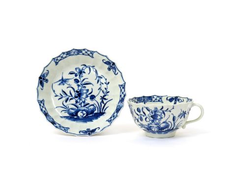 A Worcester blue and white teacup and saucer  c.1770, of Warmstry fluted form, painted with the Hollow Rock Lily pattern, a b