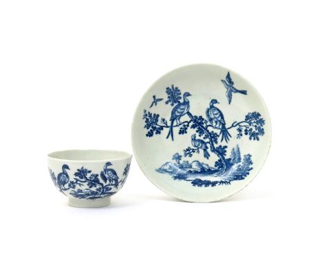 A Worcester blue and white teabowl and saucer  c.1770, printed with the Birds in Branches pattern, hatched crescent marks, 12