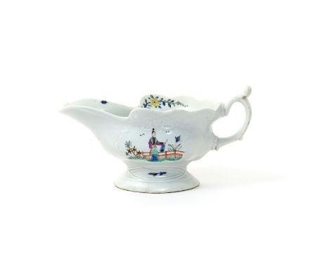 A Worcester high-footed moulded sauceboat  c.1753-54, one side painted with a chinoiserie scene of a figure crossing a bridge
