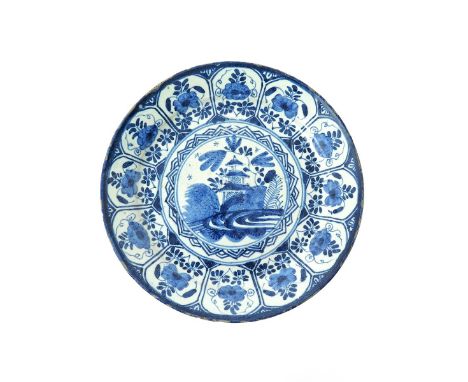 An early delftware small plate  c.1710, the well painted with a three-storeyed pagoda within a circular panel with overlappin