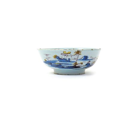 A Bristol delftware small bowl  mid 18th century, painted in blue, manganese and yellow with a low building on an island in a