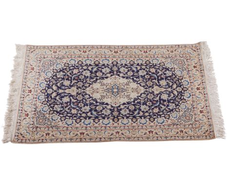 Silk, wool, and cotton rug or carpet, the deep blue field with a design of birds and flowers. The central cream medallion sus