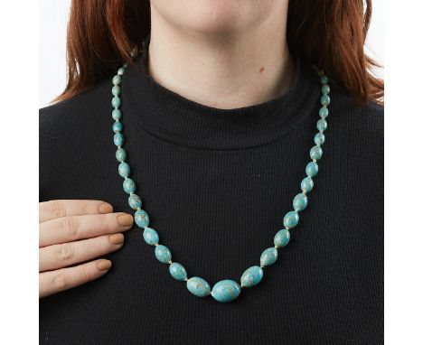 Turquoise beaded necklace comprised of 47 oval turquoise beads and one inset turquoise stone in the clasp.Length: 27 in. Gros